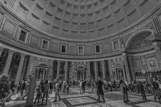 Black-and-white view inside domed Pantheon with visitors below.