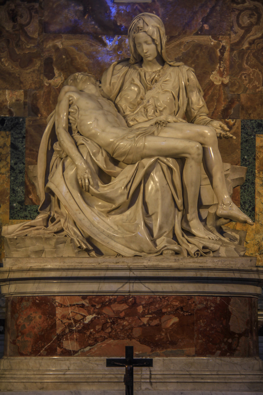 Marble sculpture of a seated figure holding a reclining figure.