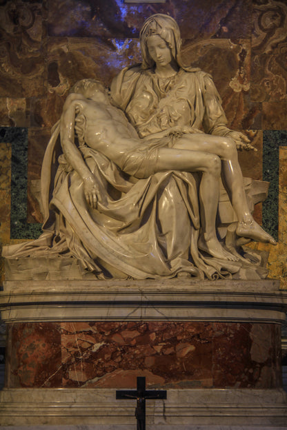 Marble sculpture of a seated figure holding a reclining figure.