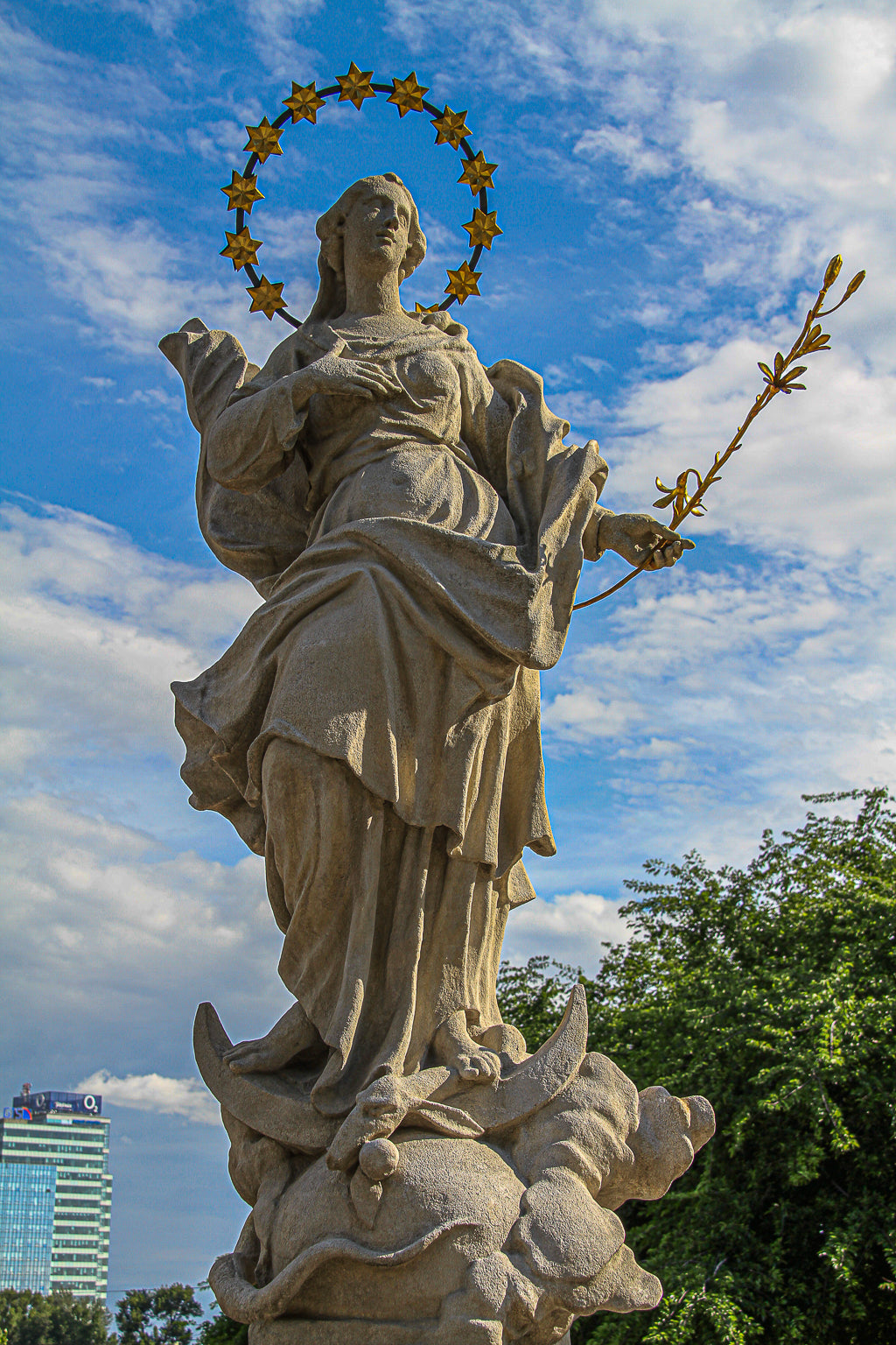 Large stone statue against a bright blue sky.